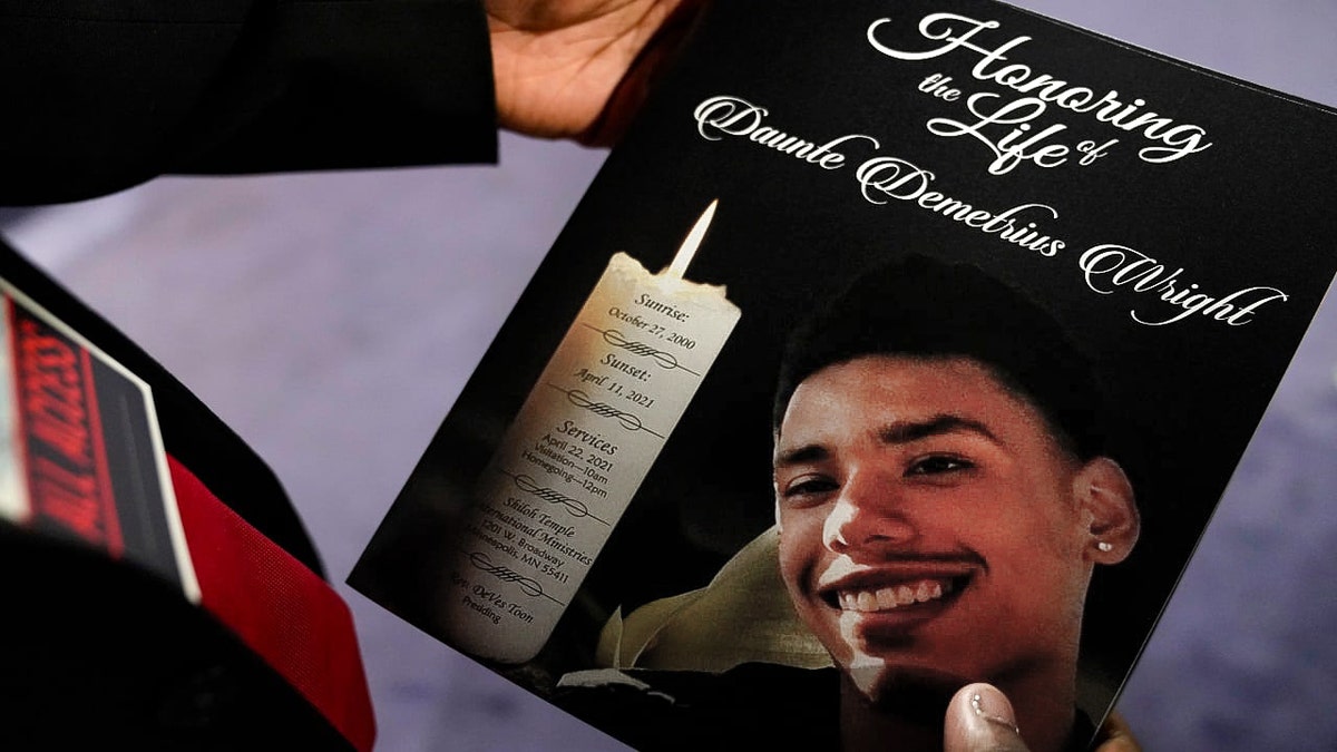 The program for the funeral services of Daunte Wright is held by a mourner at Shiloh Temple International Ministries in Minneapolis, Thursday, April 22, 2021. Wright, 20, was fatally shot by a Brooklyn Center, Minn., police officer during a traffic stop. (Associated Press) 