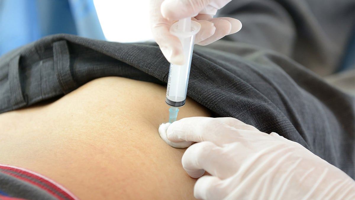 Doctor giving patient shot