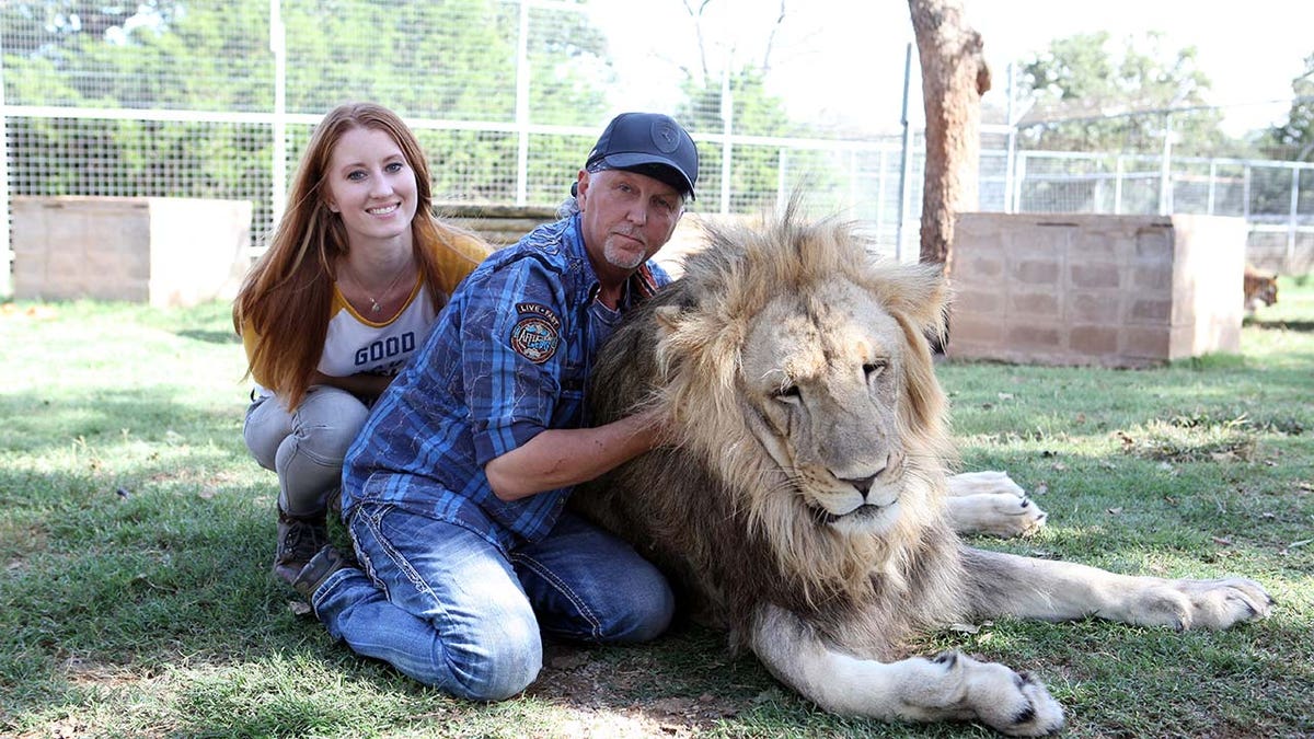 Jeff Lowe with his wife, Lauren, and a lion