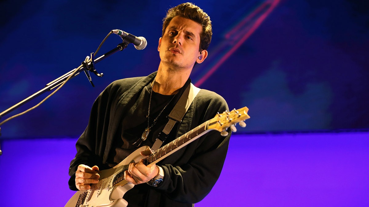 John Mayer playing a guitar