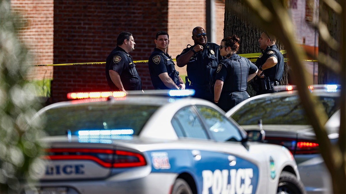 Knoxville police work the scene following a shooting at Austin-East Magnet High School in Knoxville, Tenn., Monday, April 12, 2021. (AP Photo/Wade Payne)
