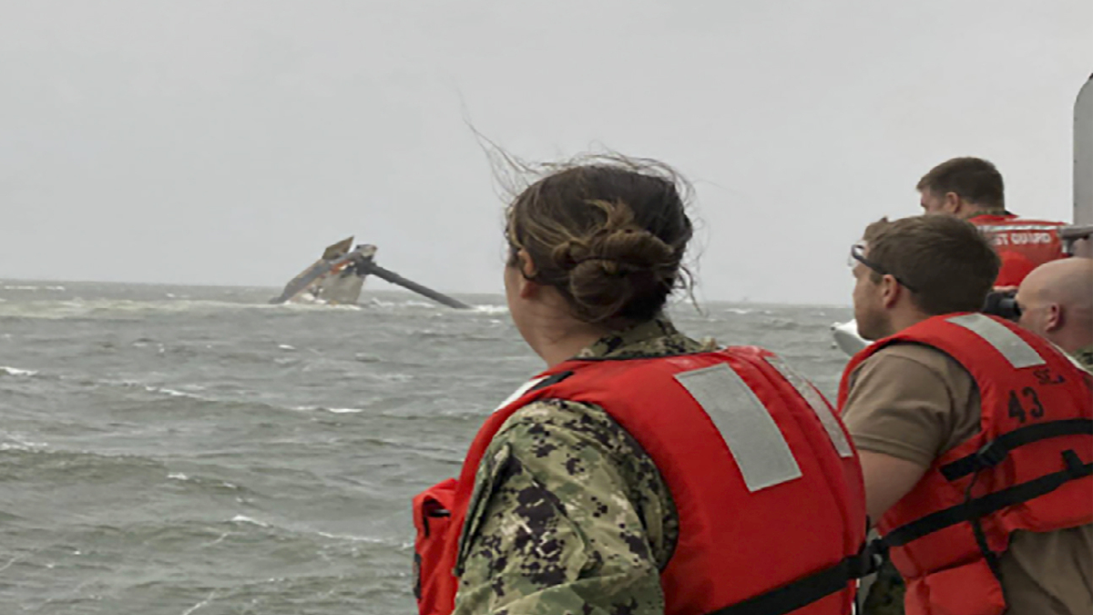 Coast Guard members scan the water Tuesday while searching for those missing after the Seacor Power, a 129-foot-ship, overturned near Louisiana. (AP/U.S. Coast Guard)