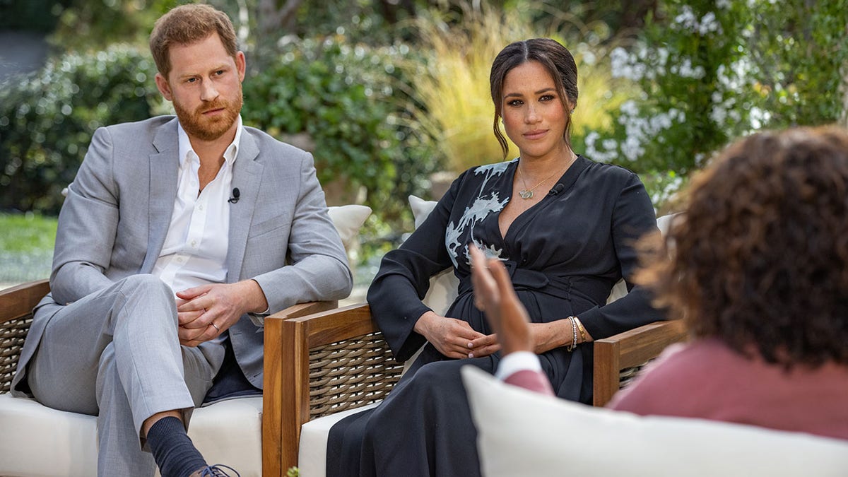 In this handout image provided by Harpo Productions and released on March 5, 2021, Oprah Winfrey interviews Prince Harry and Meghan Markle in California. The couple showed their chickens, which live in a coop known as 'Archie’s Chick Inn' during their interview with the media mogul.