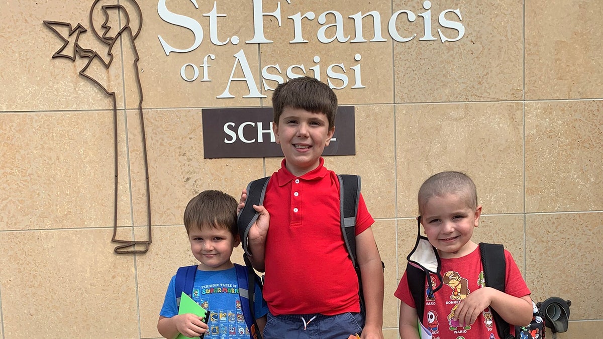 Nathan Herber, his twin bother Justin, and older brother Grant at St. Francis of Assisi in Rochester, Minnesota. 