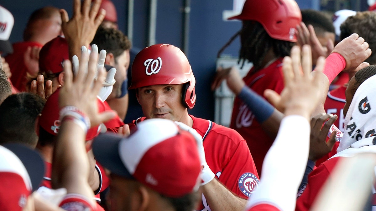 Washington Nationals' Ryan Zimmerman is congratulated in the dugout after hitting a two-run home run during the second inning of a spring training baseball game against the Houston Astros, Wednesday, March 24, 2021, in West Palm Beach, Fla. (AP Photo/Lynne Sladky)