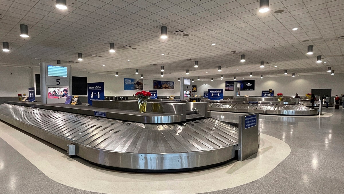 Empty baggage carousels in Terminal 2 of the Oakland International Airport, Friday Dec. 25, 2020, in Oakland, California. 