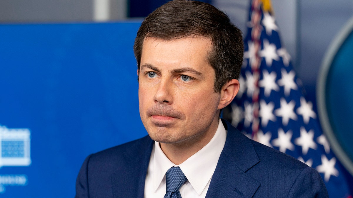 Transportation Secretary Pete Buttigieg takes a question from a reporter at a press briefing at the White House, Friday, April 9, 2021, in Washington. (AP Photo/Andrew Harnik)