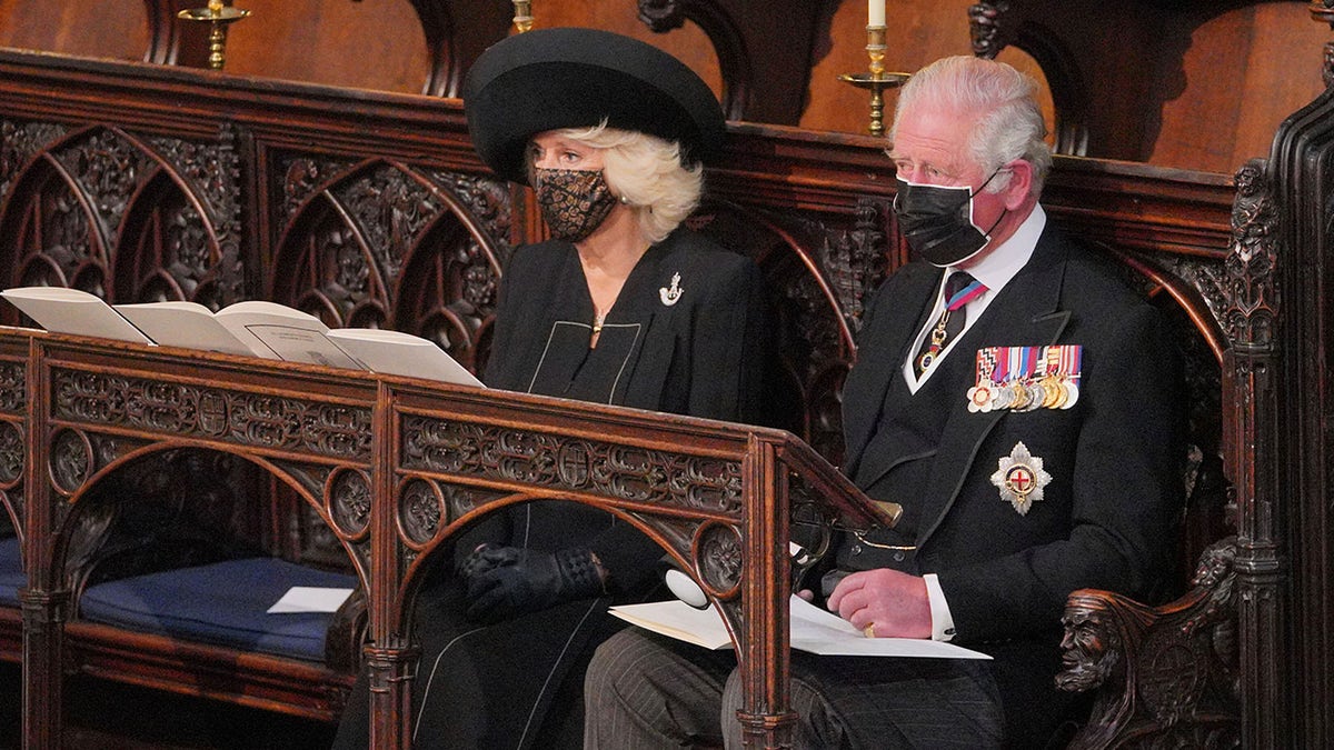 Britain's Prince Charles and Camilla, Duchess of Cornwall, look on during the funeral of Prince Philip, at St George's Chapel in Windsor Castle, Windsor, England, Saturday April 17, 2021. Prince Philip died April 9 at the age of 99 after 73 years of marriage to Britain's Queen Elizabeth II. 