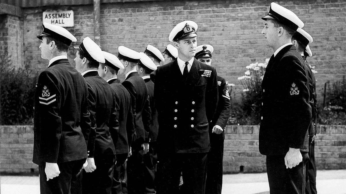In this July 31, 1947 file photo, Lt. Philip Mountbatten, as he was then called, center, inspects his men at the Petty Officers' Training Center at Corsham, England. (AP Photo/File)