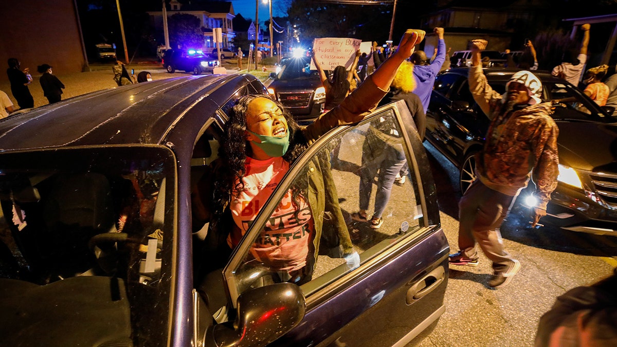 A motorist joins other protesters marching in the evening after family members were shown body camera footage of a deputy sheriff shooting and killing Black suspect Andrew Brown Jr. last week, in Elizabeth City, North Carolina, on April 26, 2021. REUTERS/Jonathan Drake