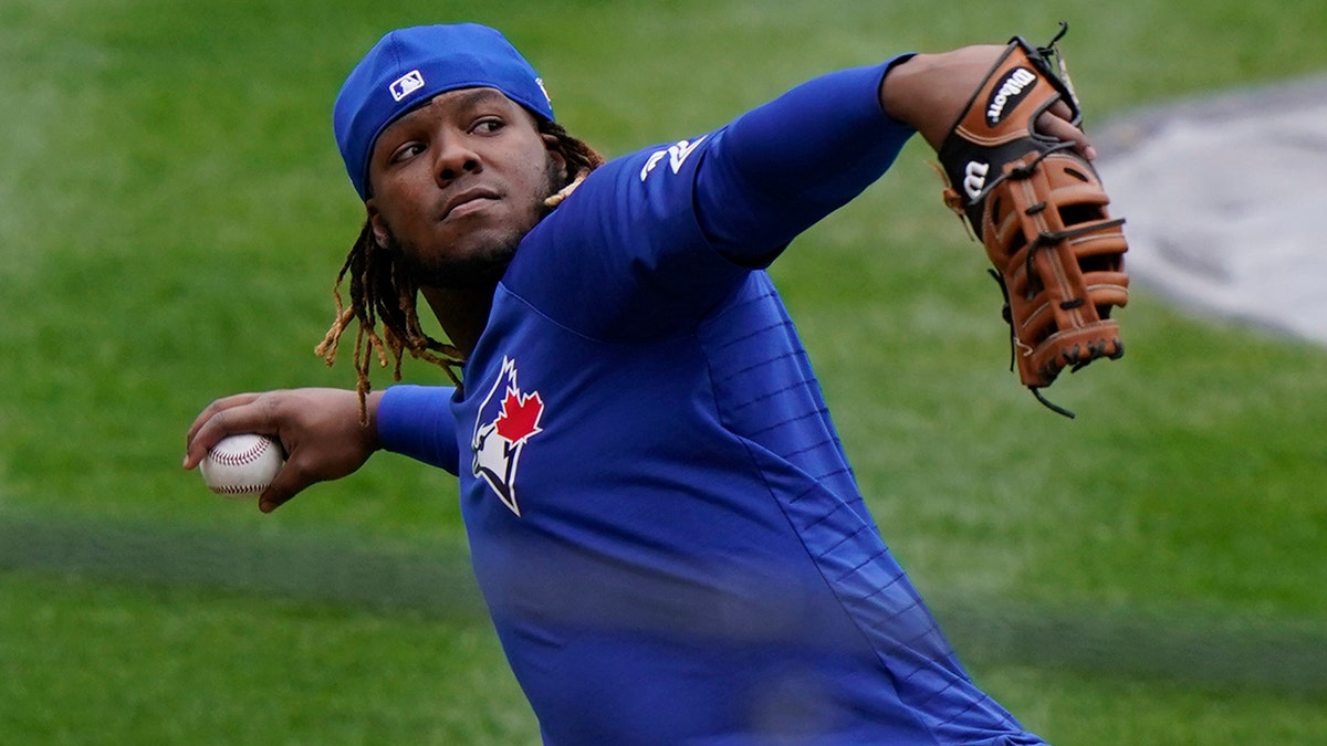 Toronto Blue Jays Vladimir Guerrero Jr. prepares to throw the ball in fielding drills during a workout, Wednesday, March 31, 2021, at Yankee Stadium in New York. The Blue Jays face the New York Yankees on opening day Thursday in New York. (AP Photo/Kathy Willens)