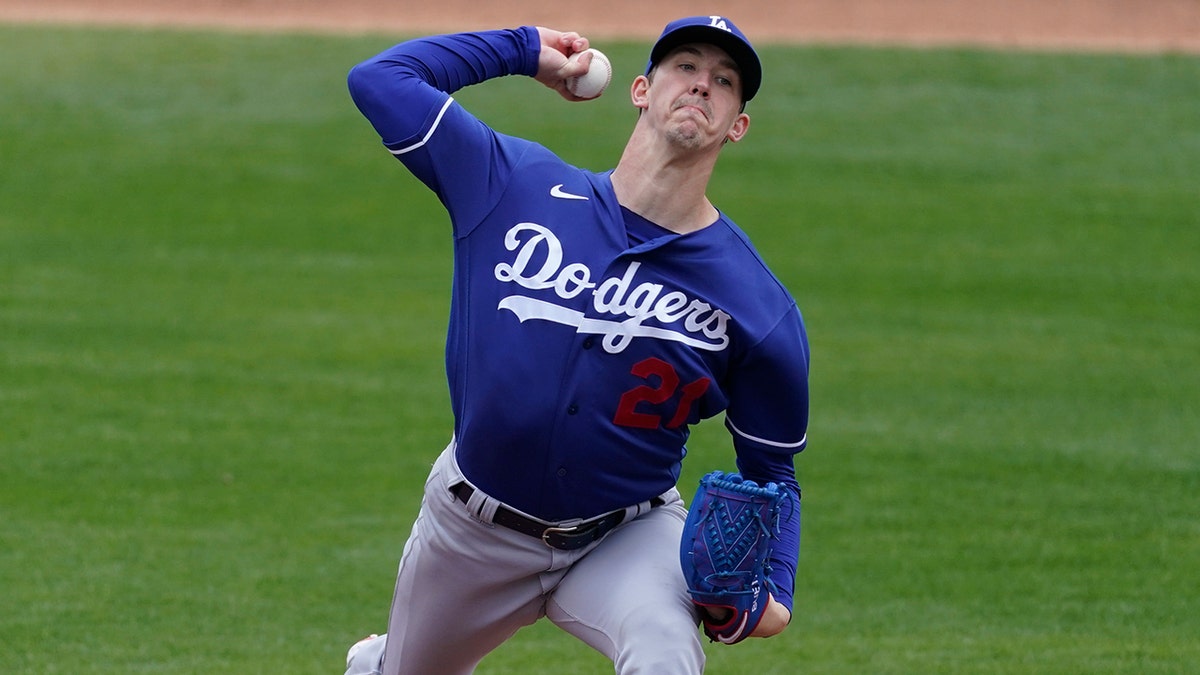 Los Angeles Dodgers starting pitcher Walker Buehler (21) throws during the first inning of a spring training baseball game against the Milwaukee Brewers Tuesday, March 23, 2021, in Phoenix, Ariz. (AP Photo/Ashley Landis)
