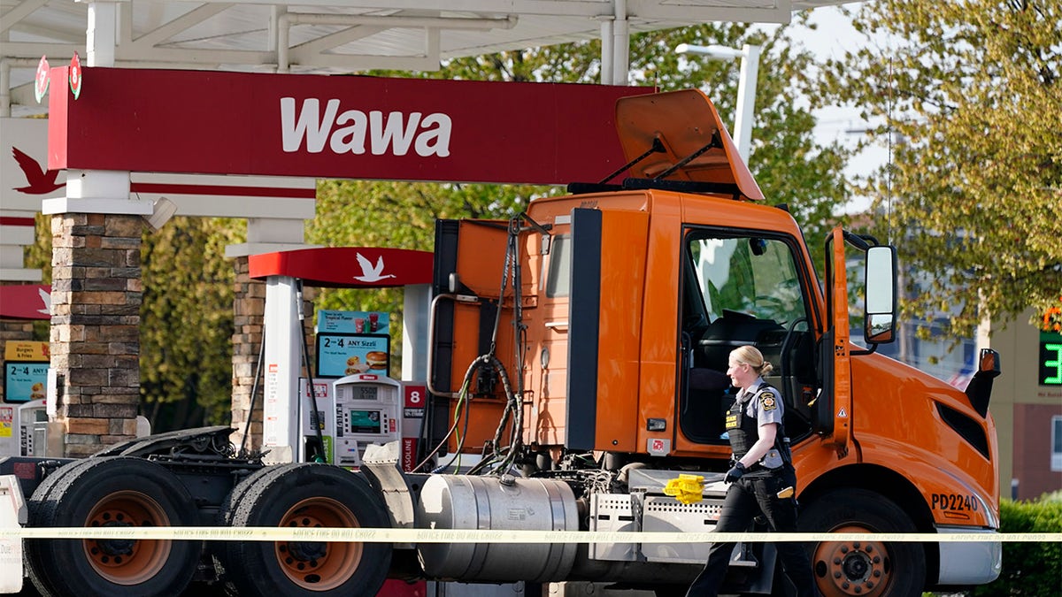 An investigator works the crime scene at a Wawa convenience store and gas station in Breinigsville, Pa., Wednesday, April 21, 2021. (AP Photo/Matt Rourke)