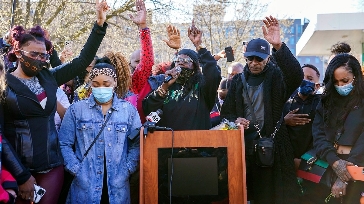 DMX'S ex-wife, Tashera Simmons, left, and his fiancé Desiree Lindstrom, second from left, are joined by family and friends as they pray during a prayer vigil outside of White Plains Hospital on Monday.