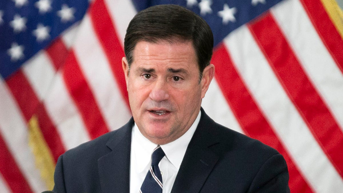 Dec 16, 2020; Phoenix, AZ, USA; Arizona Governor Doug Ducey speaks during a press conference, as Dr. Cara M. Christ, director of the Arizona Department of Health Services, looks on, at the Banner Health COVID-19 vaccine point of distribution at the Arizona State Fairgrounds in Phoenix on December 16, 2020. People will begin receiving COVID-19 vaccines at this drive-thru facility in the coming days. Mandatory Credit: David Wallace/The Arizona Republic via USA TODAY NETWORK