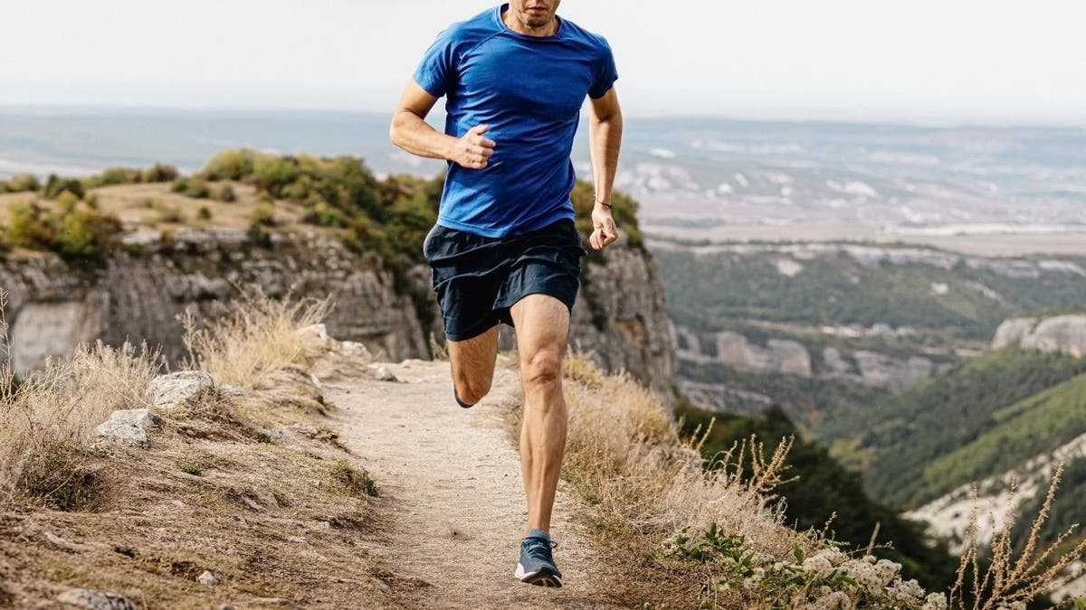 Man running on rocky trail