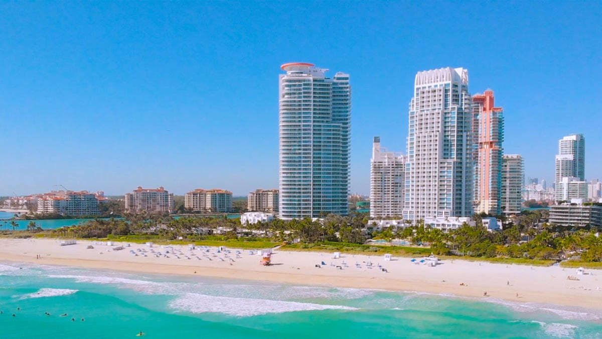 Aerial flight Miami Beach waves and surfboarders