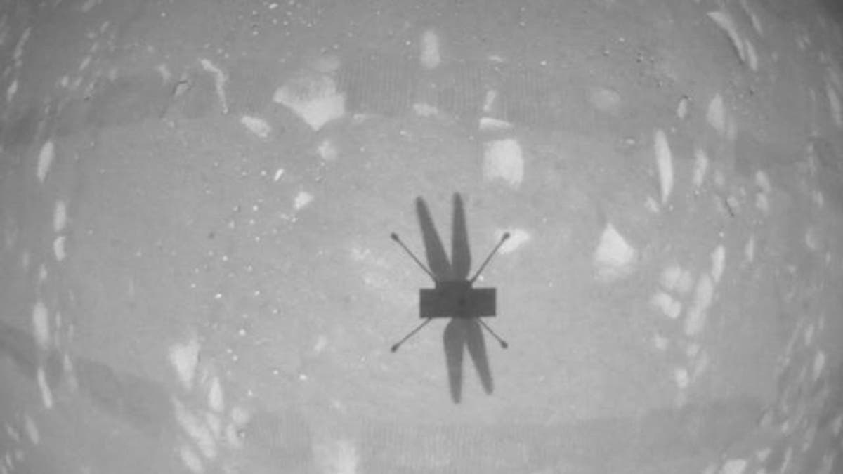 The Ingenuity Mars Helicopter's navigation camera captures the helicopter's shadow on the surface of Jezero Crater during rotorcraft's second experimental test flight on April 22, 2021.