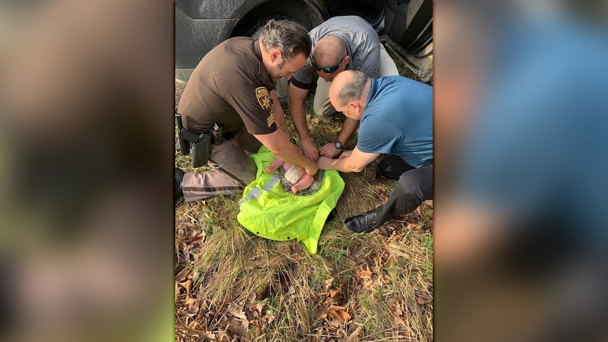 Michigan deputies found an abandoned 4-month-old baby in the woods Wednesday morning after responding to reports of a distraught, erratic woman banging on doors in the area.