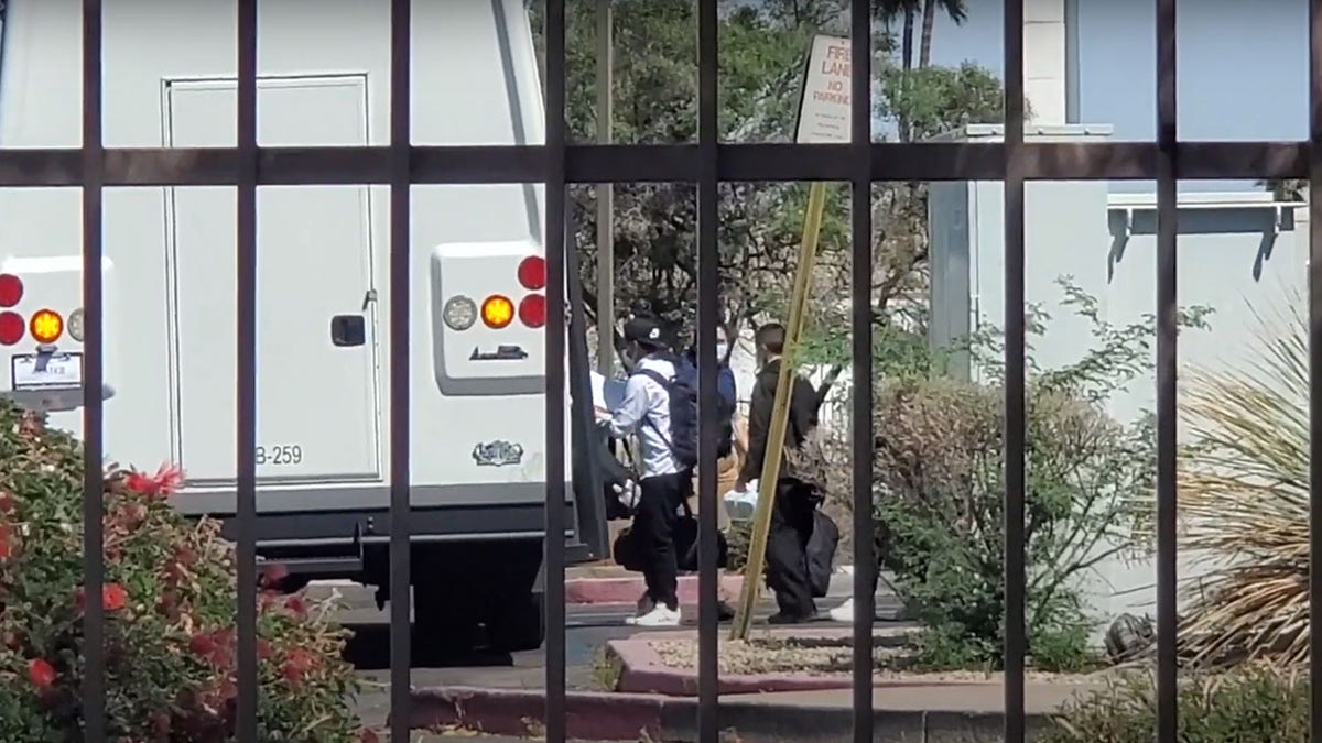 Migrants at hotels in Arizona are seen being transported.
