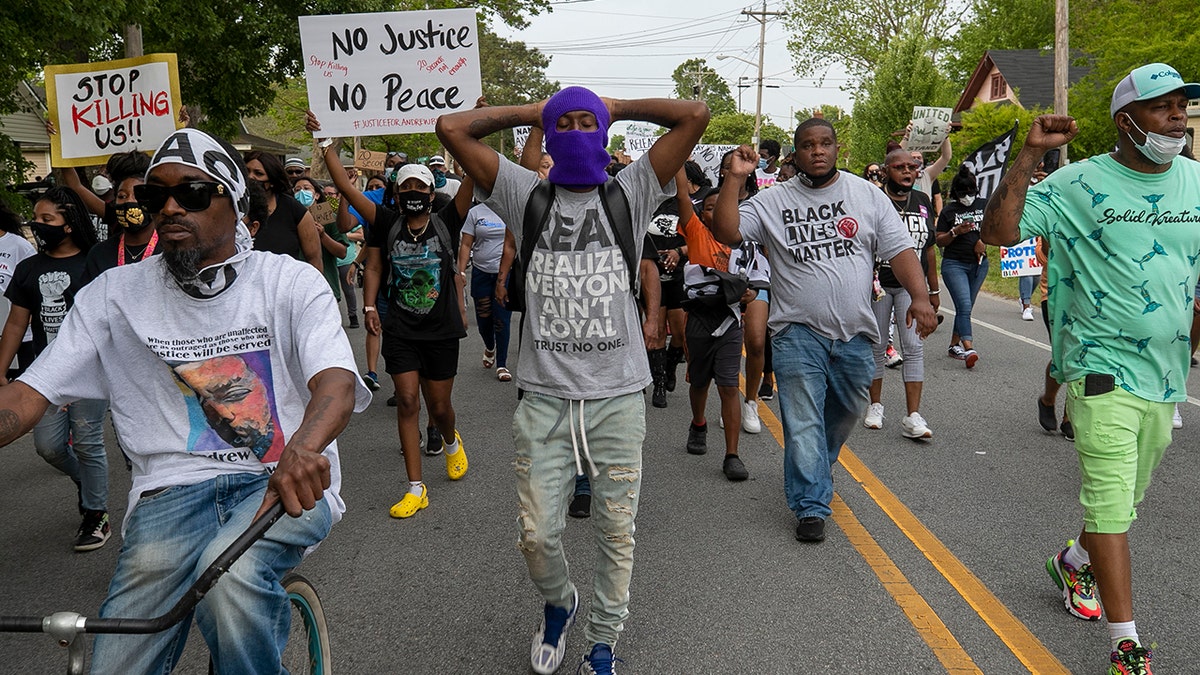 Elizabeth City Councilman Gabriel Adkins, second from right wearing a Black Lives Matter shirt, helps lead demonstrators on a march through Andrew Brown Jr.'s neighborhood, Thursday, April 29, 2021, in Elizabeth City, N.C. (Robert Willett/The News &amp; Observer via AP)