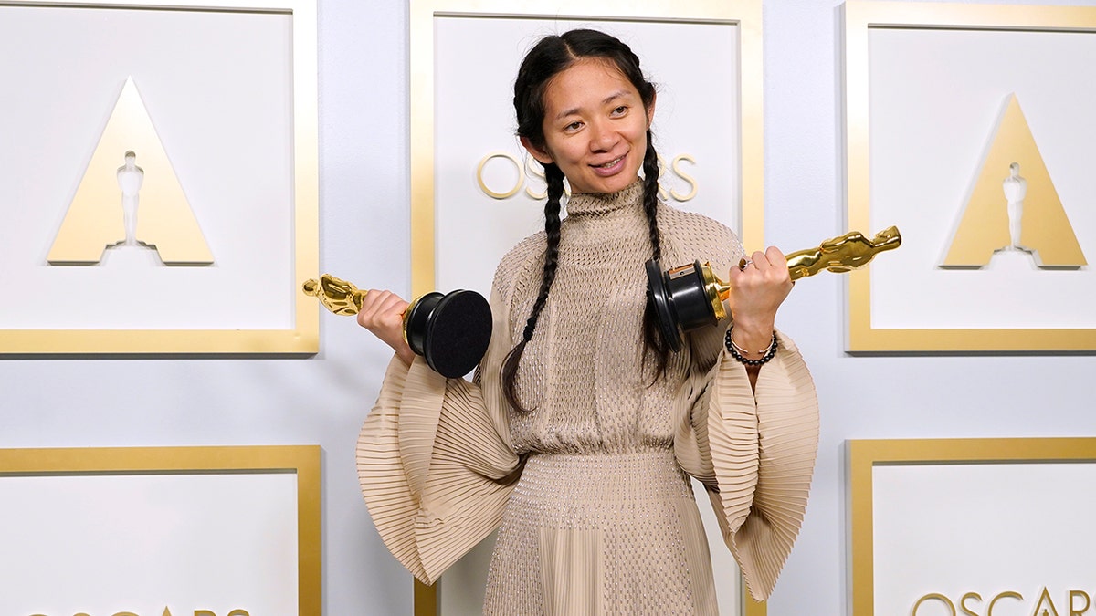 Chloe Zhao holding Oscars