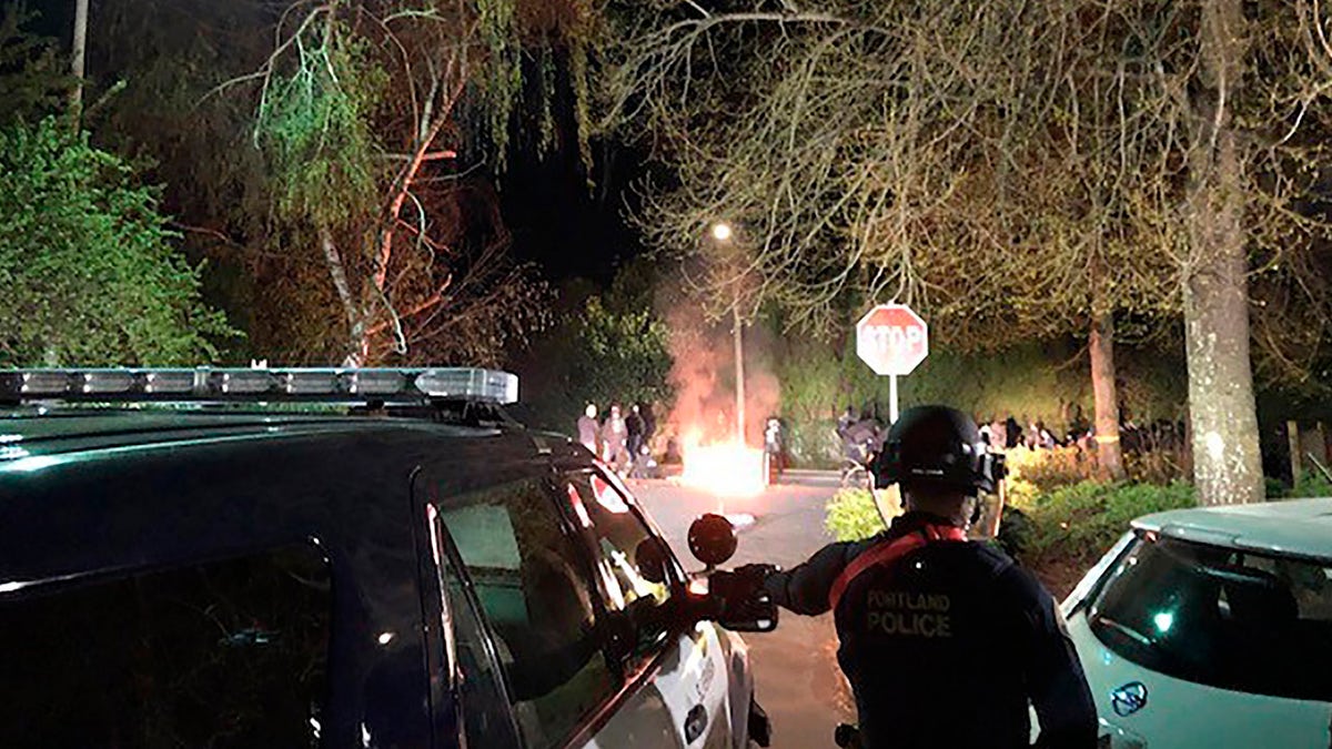 Portland police line up outside of the Penumbra Kelly Building in downtown Portland, Ore., on Monday. Police say a demonstration protesting the police killing of 20-year-old Daunte Wright in Minnesota turned into a riot, with some in the crowd throwing rocks and other projectiles at officers.