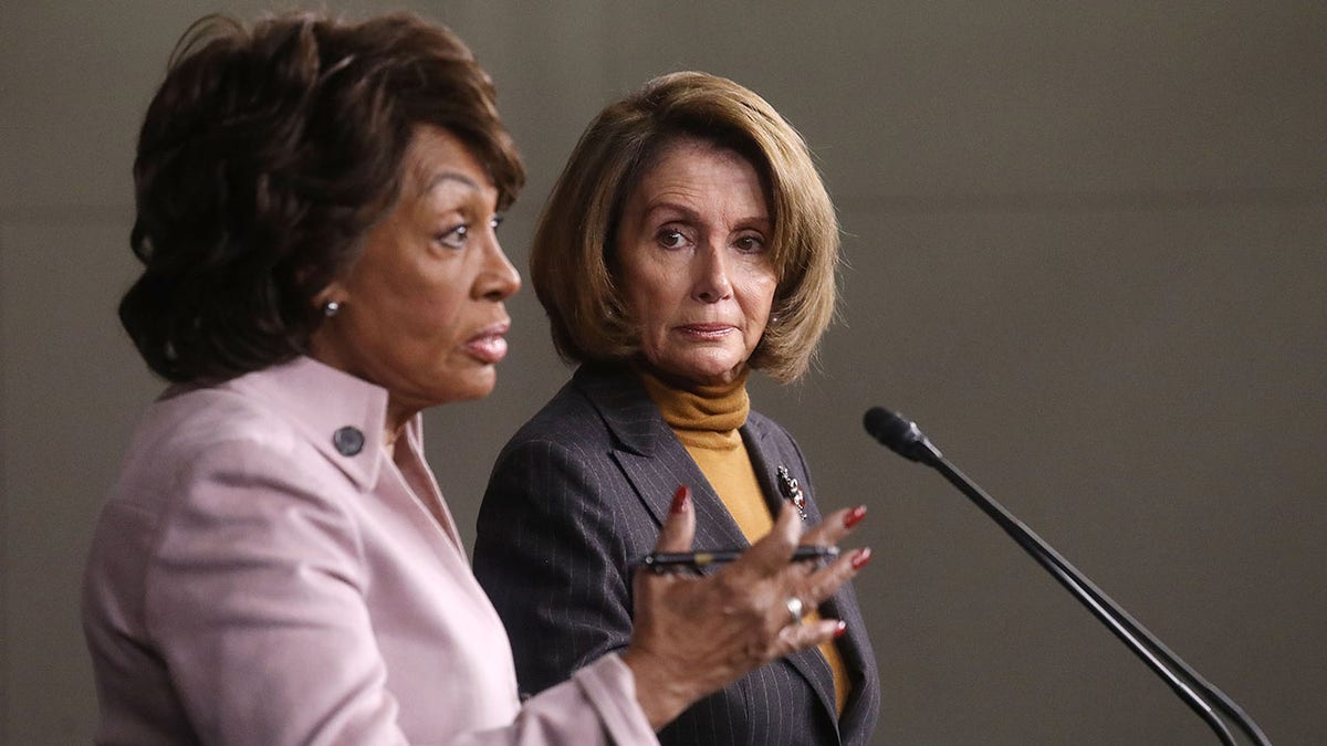 House Speaker Nancy Pelosi looks on as Rep. Maxine Waters speaks at a news conference criticizing then-President Trump's Wall Street policies on Capitol Hill on Feb. 6, 2017. (Mario Tama/Getty Images)