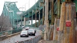 Drivers take an exit ramp off the Tobin Memorial Bridge, Wednesday, March 31, 2021, in Chelsea, Mass. President Joe Biden wants $2 trillion to reengineer America's infrastructure and expects the nation's corporations to pay for it. The Tobin Bridge spans the Mystic River and links Boston and Chelsea. (AP Photo/Steven Senne)