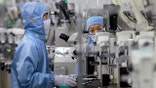 FILE - In this May 14, 2020, file photo, employees wearing protective equipment work at a semiconductor production facility for Renesas Electronics during a government organized tour for journalists in Beijing. China has announced tax breaks to spur growth of its semiconductor industry following U.S. sanctions that cut off access to American processor chips for tech giant Huawei and some other companies. (AP Photo/Mark Schiefelbein, File)