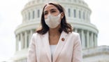 US Representative Alexandria Ocasio-Cortez, Democrat of New York, attends a press conference about a postal banking pilot program outside the US Capitol in Washington, DC, April 15, 2021. (Photo by SAUL LOEB / AFP) (Photo by SAUL LOEB/AFP via Getty Images)
