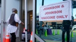 FILE - In this April 1, 2021 file photo, people walk in to get their COVID-19 vaccine at the Baldwin Hills Crenshaw Plaza in Los Angeles. The U.S. is recommending a “pause” in administration of the single-dose Johnson &amp; Johnson COVID-19 vaccine to investigate reports of potentially dangerous blood clots. In a joint statement Tuesday, the Centers for Disease Control and Prevention and the Food and Drug Administration said it was investigating clots in six women in the days after vaccination, in combination with reduced platelet counts.  (AP Photo/Damian Dovarganes)
