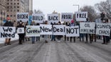 People hold signs calling for President Joe Biden to support a Green New Deal and end his support of pipelines and the fossil fuel industry. St. Paul, MN. January 29, 2021.  Nearly 600 activists and water protectors took part in a protest against the Enbridge Line 3 pipeline on Friday evening in St. Paul, Minnesota. The event was organized by over a dozen groups, including Sunrise Movement MN, Honor the Earth, International Indigenous Youth Council, Environment MN, MN350, and others. Participants called for Governor Tim Walz as well as the Army Corp of Engineers to revoke the pipelines permit on environmental safety and humanitarian grounds, as well as to respect the treaty rights of the various Anishinabe tribes whose territories the pipeline crosses. (Photo by Tim Evans/NurPhoto via Getty Images)