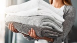 Cropped shot of an unrecognizable young woman doing her laundry at home