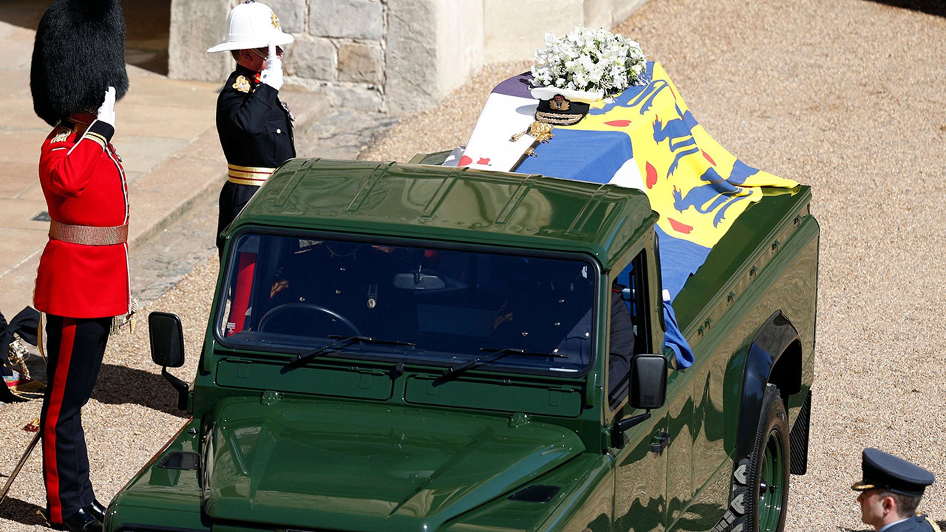 Members of the armed forces pay tribute to Prince Philip, Duke of Edinburgh, during the funeral procession Saturday to St. George's Chapel in Windsor Castle. Philip, who was married to Queen Elizabeth II for 73 years, died April 9 at the age of 99. (Photo by Adrian DENNIS / POOL / AFP) (Photo by ADRIAN DENNIS/POOL/AFP via Getty Images)