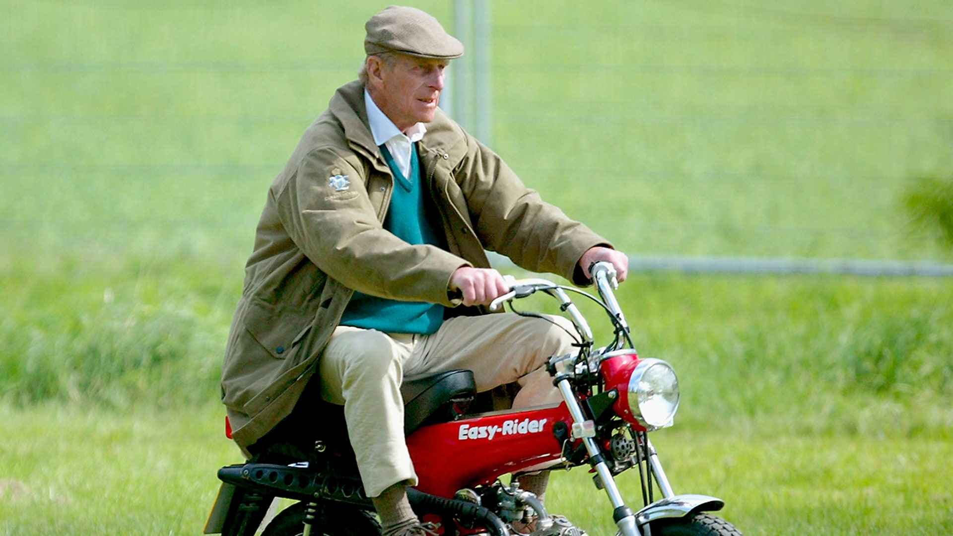 WINDSOR, ENGLAND - MAY 13: HRH The Duke of Edinburgh rides on his mini motorbike during the Royal Windsor Horse Show at Home Park, Windsor Castle on May 13, 2005 in Windsor, England. (Photo by Julian Finney/Getty Images)