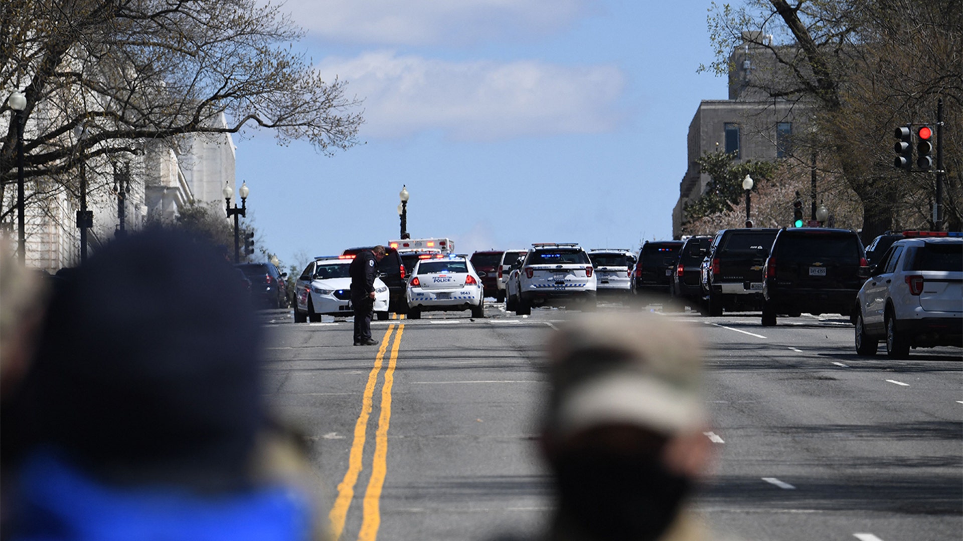 Police block a street near the US Capitol on April 2, 2021, after a vehicle drove into US Capitol police officers in Washington, DC. - Two police officers were injured near the US Capitol on Friday after being rammed by a vehicle whose driver was subsequently arrested, police said. "A suspect is in custody. Both officers are injured. All three have been transported to the hospital," the US Capitol Police department said on Twitter. (Photo by Eric BARADAT / AFP) (Photo by ERIC BARADAT/AFP via Getty Images)