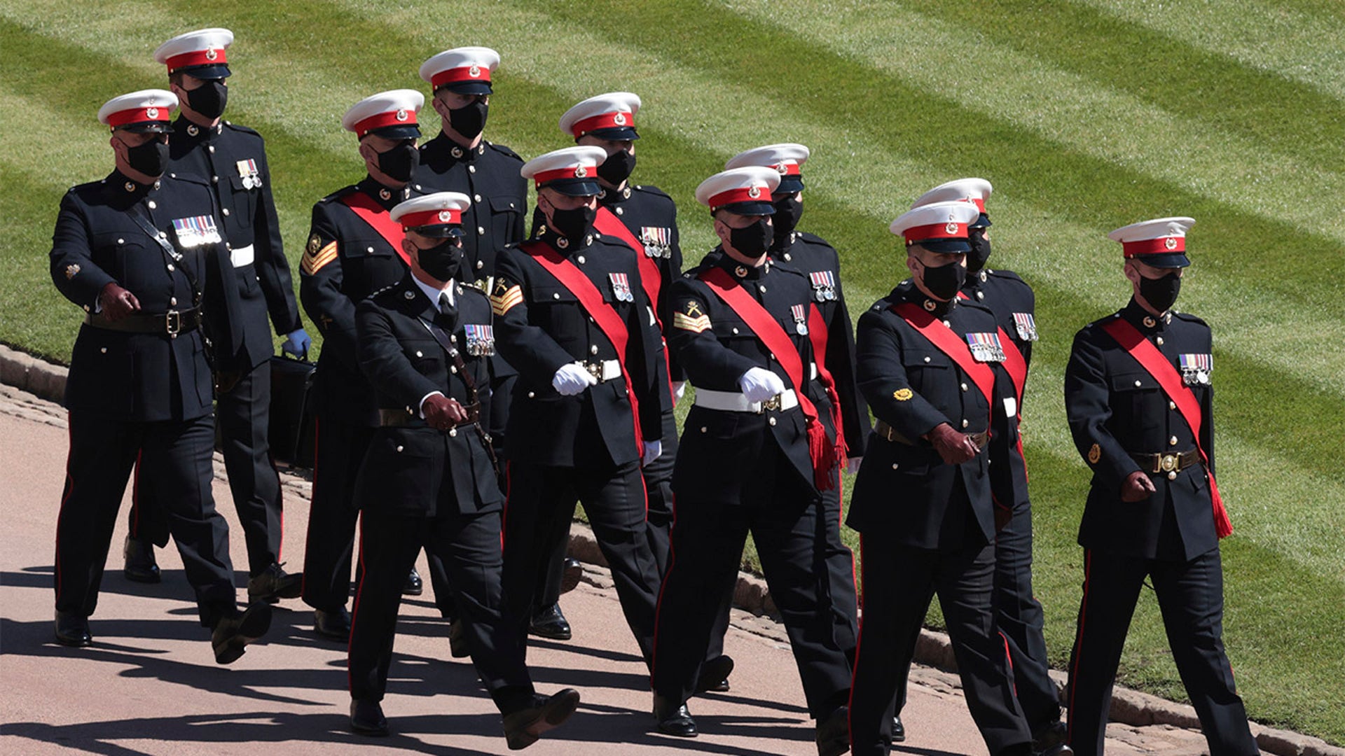 Soldiers walk through the entrance of Windsor Castle ahead of the funeral of Britain's Prince Philip in Windsor, England, on Saturday, April 17, 2021. Prince Philip died April 9 at the age of 99 after 73 years of marriage to Queen Elizabeth II. (Hannah McKay/Pool via AP)