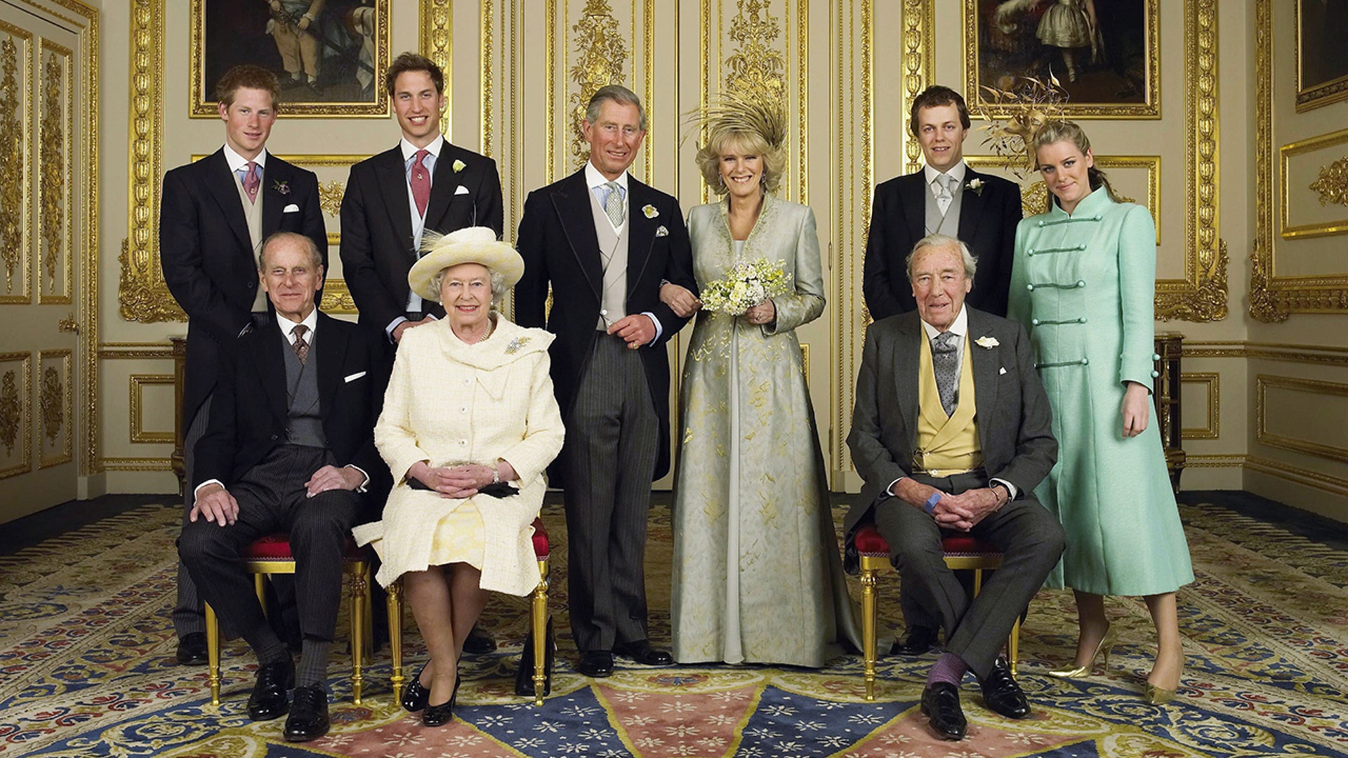 (EMBARGOED TO 0001 BST MONDAY APRIL 11 2005) WINDSOR, ENGLAND - APRIL 9: Clarence House official handout photo of the Prince of Wales and his new bride Camilla, Duchess of Cornwall, with their families (L-R back row) Prince Harry, Prince William, Tom and Laura Parker Bowles (L-R front row) Duke of Edinburgh, Britain's Queen Elizabeth II and Camilla's father Major Bruce Shand, in the White Drawing Room at Windsor Castle after their wedding ceremony, April 9, 2005 in Windsor, England. (Photo by Hugo Burnand/Pool/Getty Images)