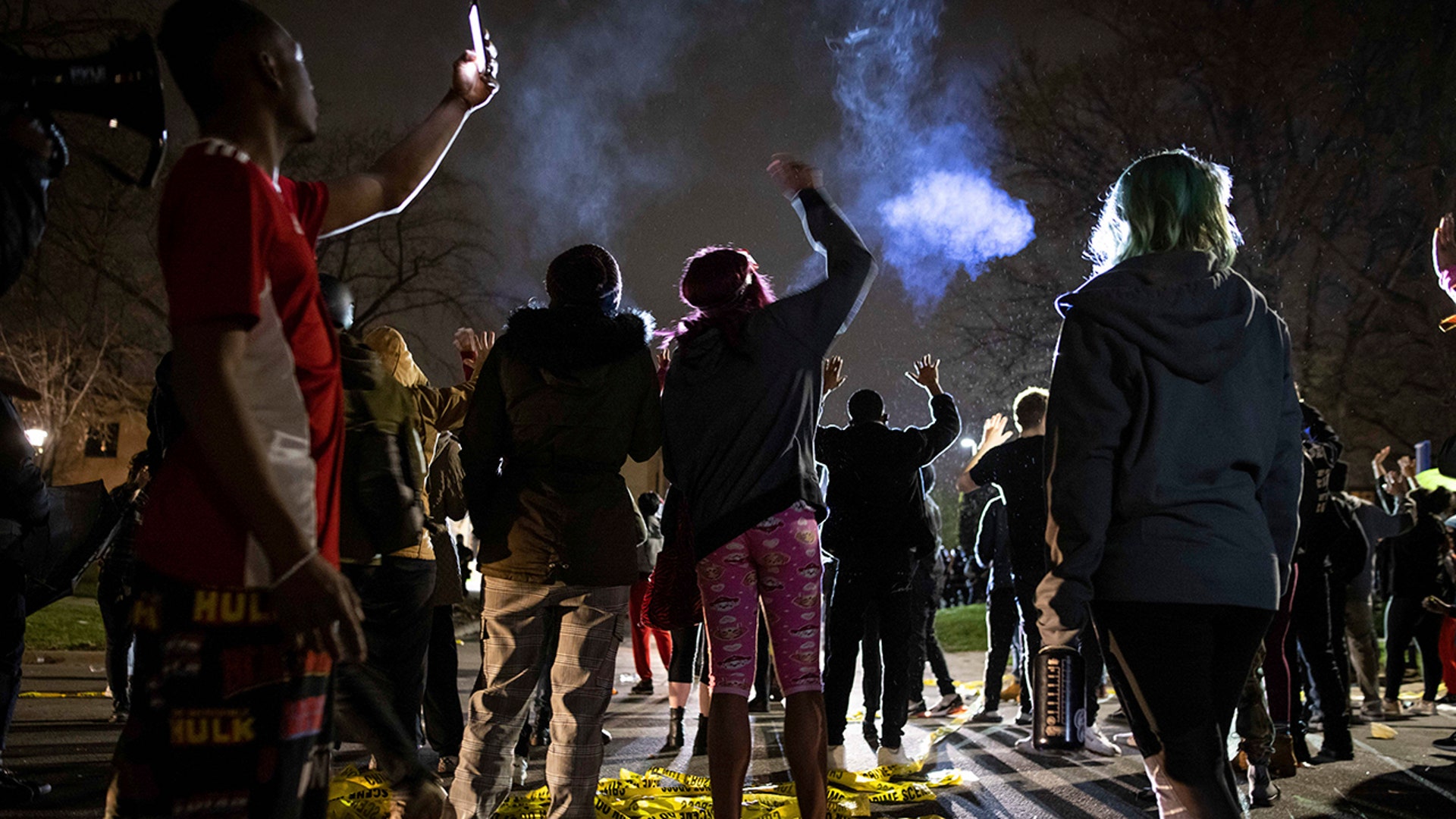 Protesters gather in front of the Brooklyn Center Police station on Sunday, April 11, 2021, in Brooklyn Center, Minnesota. The family of Daunte Wright, 20, told a crowd that he was shot by police Sunday before getting back into his car and driving away, then crashing the vehicle several blocks away. The family said Wright was later pronounced dead.