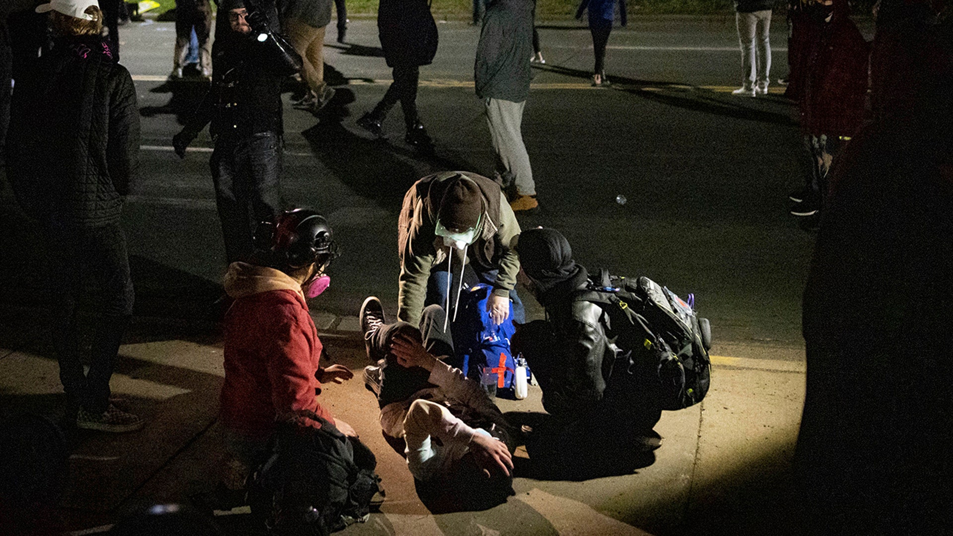 A man is injured as protesters clash with police in front of the Brooklyn Center Police station on Sunday, April 11, 2021, in Brooklyn Center, Minnesota. The family of Daunte Wright, 20, told a crowd that he was shot by police Sunday before getting back into his car and driving away, then crashing the vehicle several blocks away. The family said Wright was later pronounced dead.