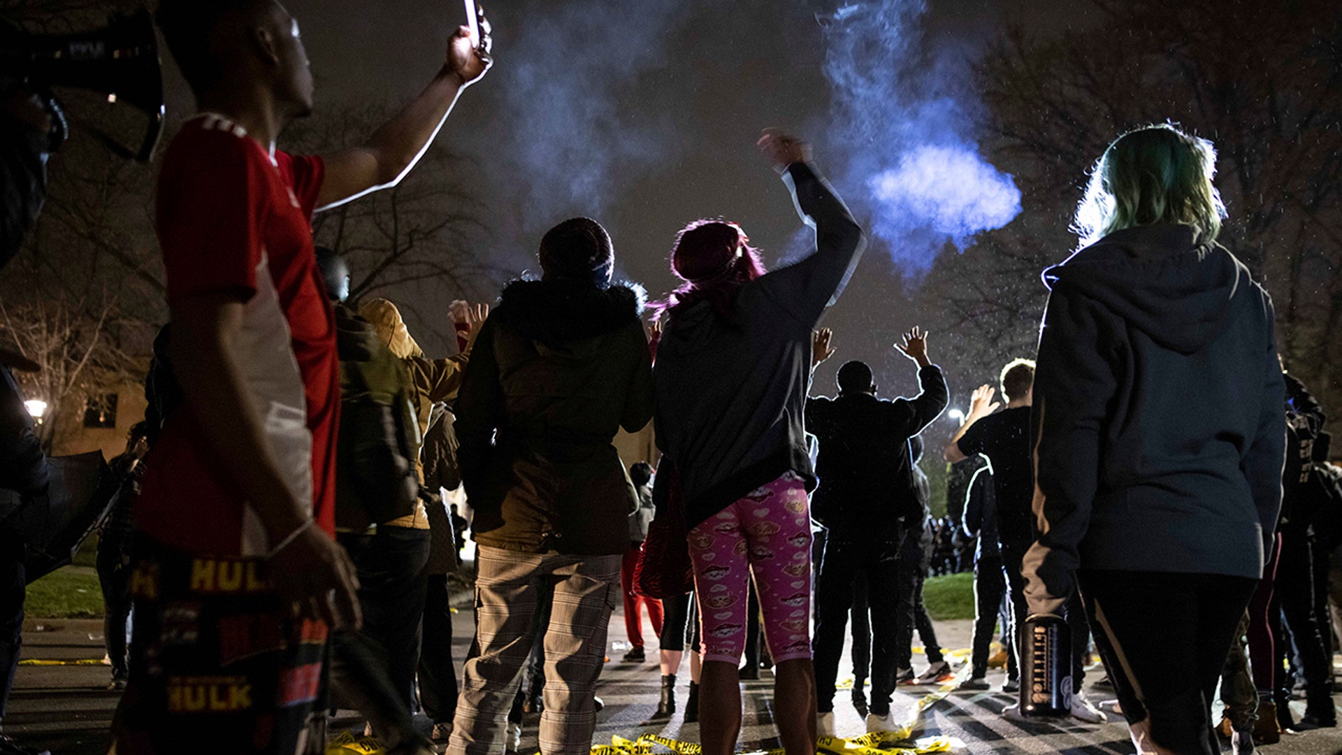 Protesters gather in front of the Brooklyn Center Police station on Sunday, April 11, 2021, in Brooklyn Center, Minnesota. The family of Daunte Wright, 20, told a crowd that he was shot by police Sunday before getting back into his car and driving away, then crashing the vehicle several blocks away. The family said Wright was later pronounced dead.