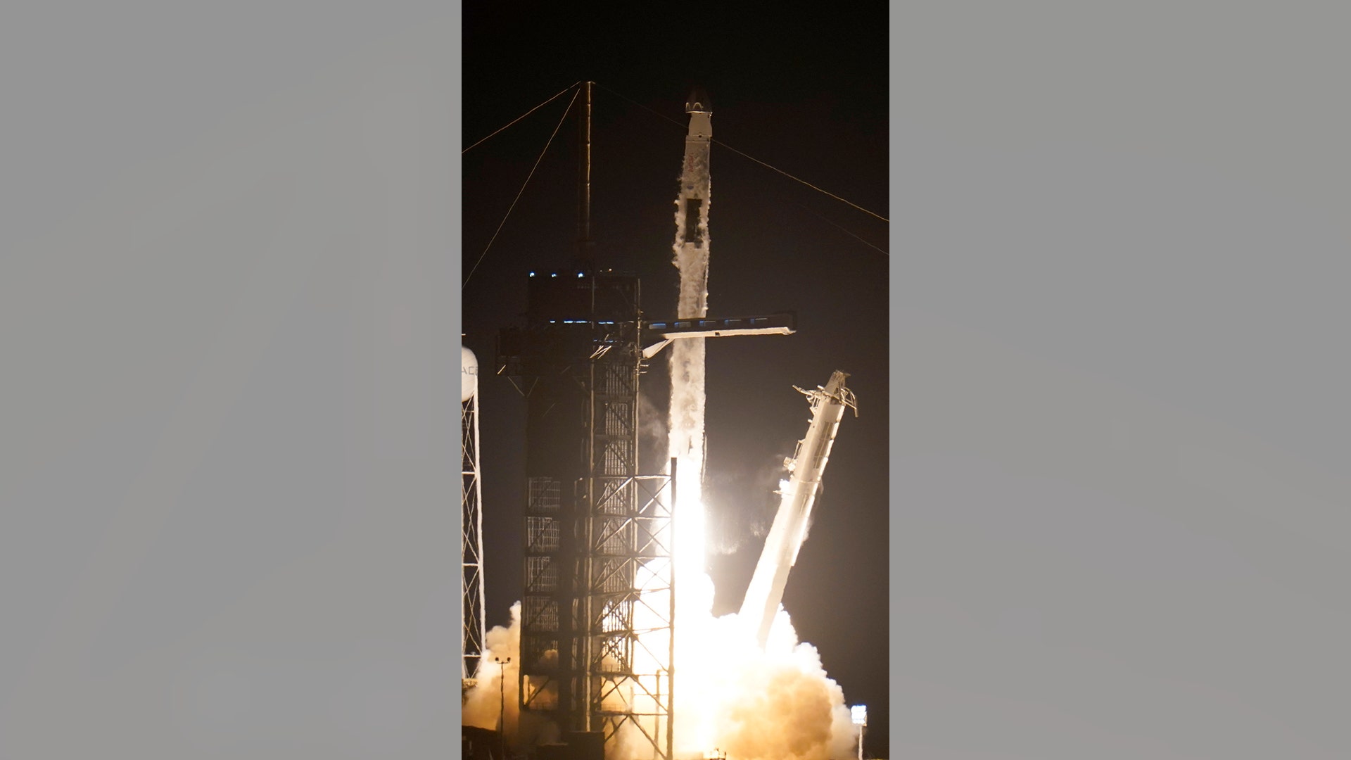 A SpaceX Falcon 9 rocket with the Crew Dragon space capsule lifts off from pad 39A at the Kennedy Space Center in Cape Canaveral, Fla., Friday, April 23, 2021. (AP Photo/John Raoux)