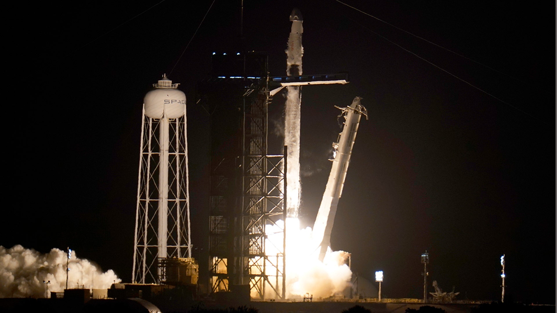 A SpaceX Falcon 9 rocket with the Crew Dragon space capsule lifts off from pad 39A at the Kennedy Space Center in Cape Canaveral, Fla., Friday, April 23, 2021. (AP Photo/John Raoux)