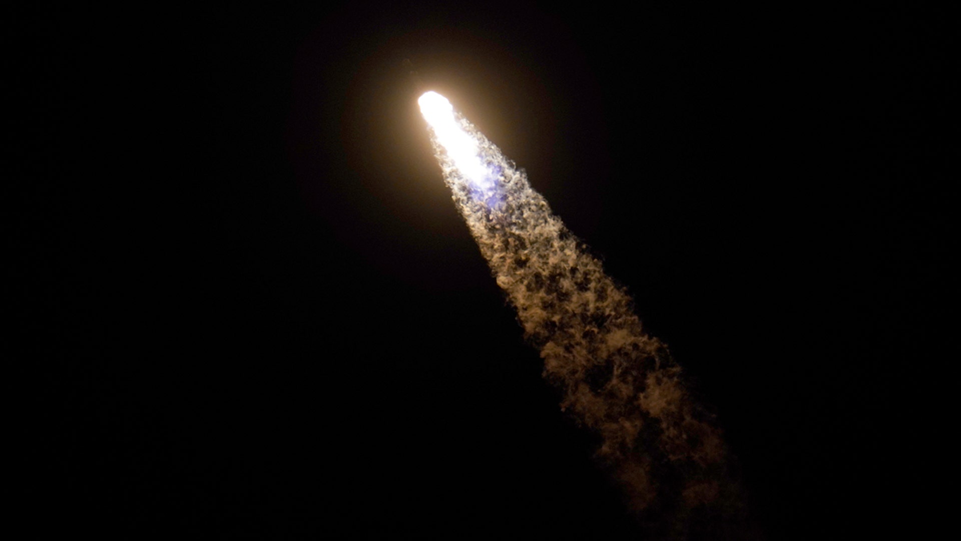 A SpaceX Falcon 9 rocket with the Crew Dragon space capsule leaves a trail of smoke as it lifts off from pad 39A at the Kennedy Space Center in Cape Canaveral, Fla., Friday, April 23, 2021. (AP Photo/John Raoux)