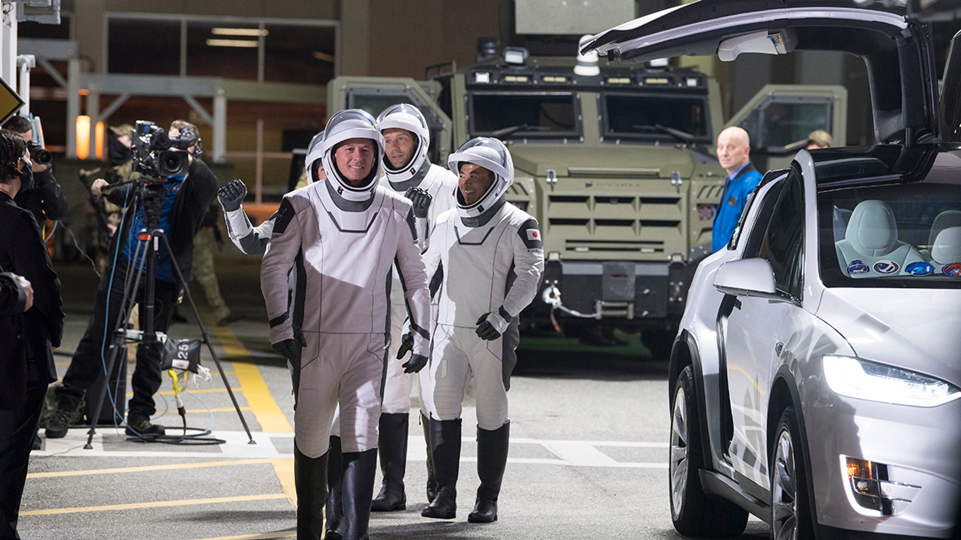 In this photo provided by NASA, NASA astronauts Shane Kimbrough, front, Japan Aerospace Exploration Agency (JAXA) astronaut Akihiko Hoshide, right, and ESA (European Space Agency) astronaut Thomas Pesquet, back, wearing SpaceX spacesuits, prepare to depart the Neil A. Armstrong Operations and Checkout Building for Launch Complex 39A to board the SpaceX Crew Dragon spacecraft for the Crew-2 mission launch, Friday, April 23, 2021, at the Kennedy Space Center in Cape Canaveral, Fla. (Aubrey Gemignani/NASA via AP)