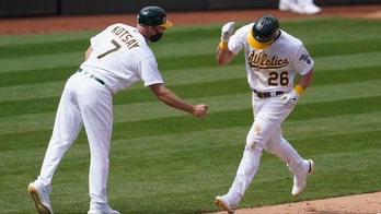 A's rally to beat Dodgers 4-3 in 10 for 1st win of season