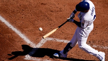 Royals outslug Rangers 14-10 in wild season opener