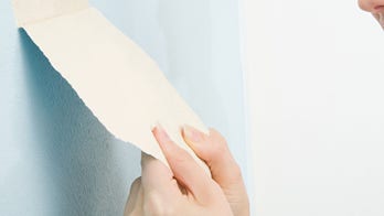 Homeowner finds strange paintings hiding behind her wallpaper