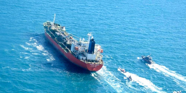 A photo obtained by AFP from the Iranian news agency Tasnim on Jan. 4, 2021, shows the South Korean-flagged tanker being escorted by Iran's Revolutionary Guards navy after being seized in the Gulf. (Getty Images)